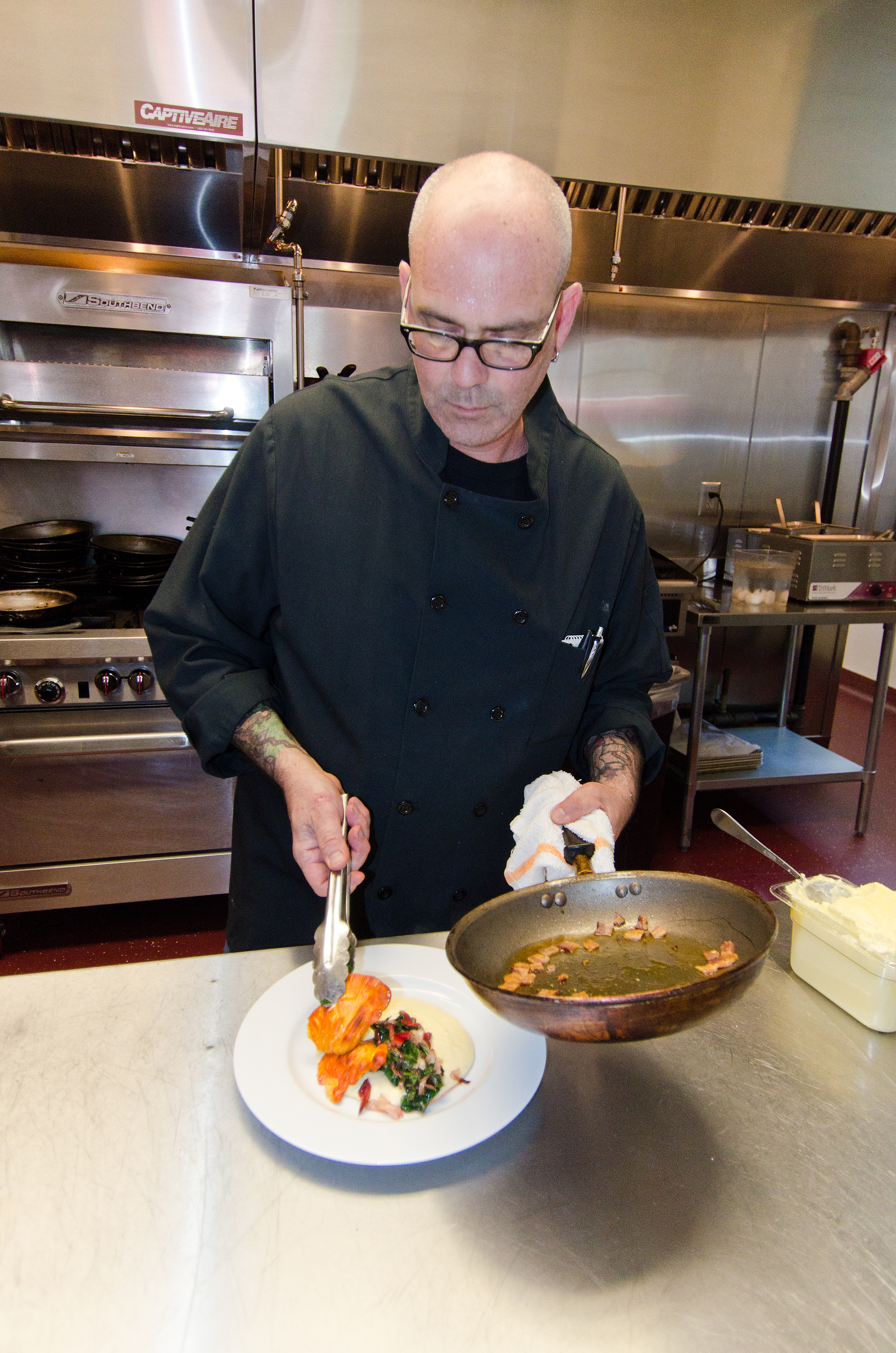 Black and white portrait of Chef Rick Matharu in his kitchen