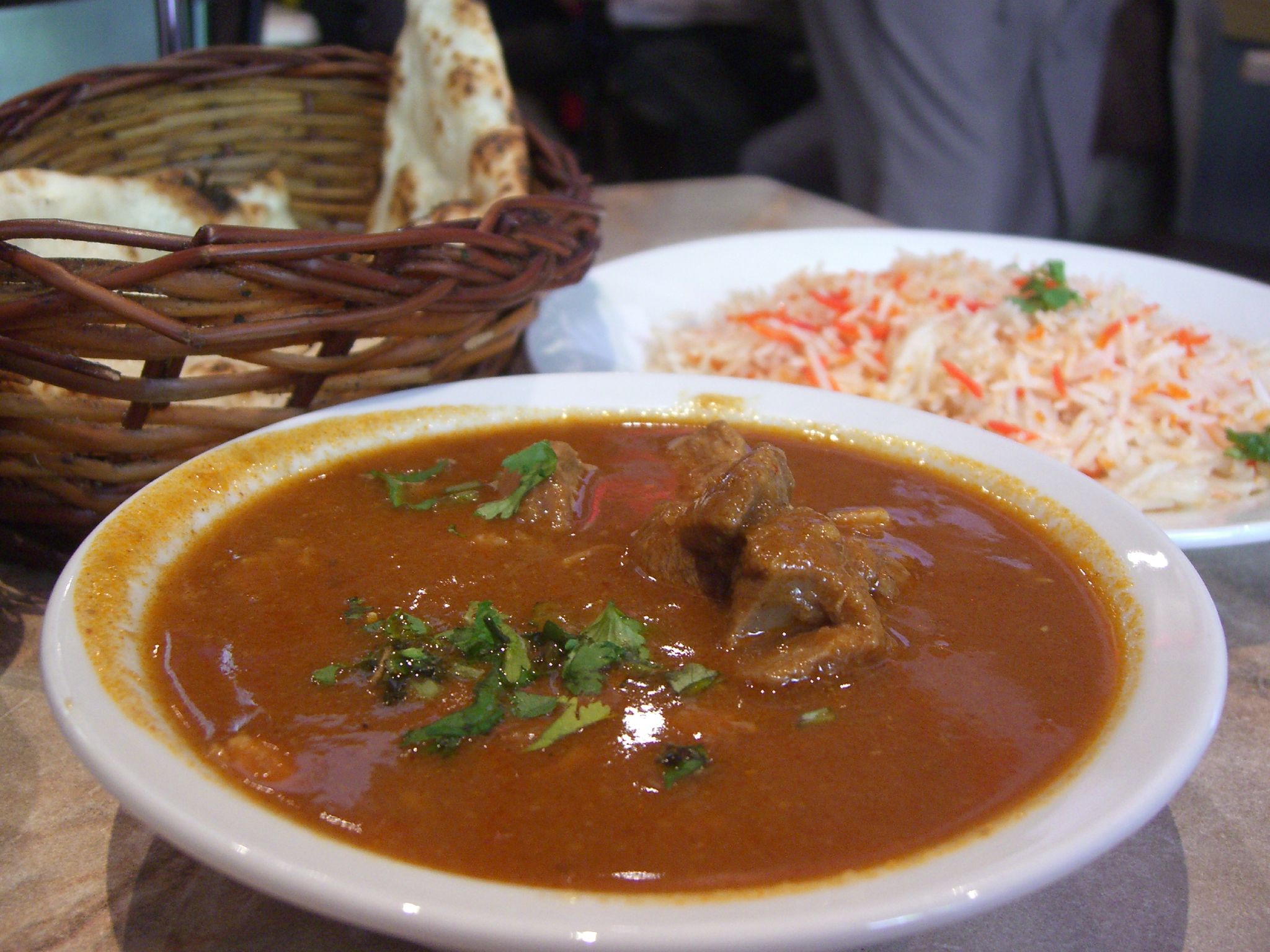 A rich, slow-cooked curry dish in a dark pot